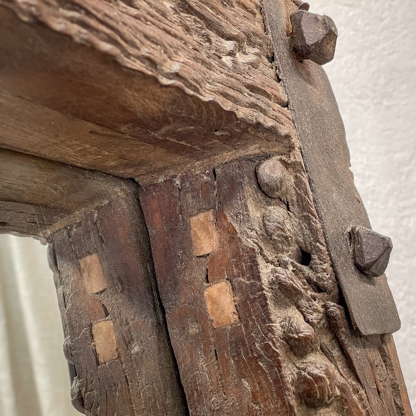 Close-up of an old wooden structure with metal brackets.