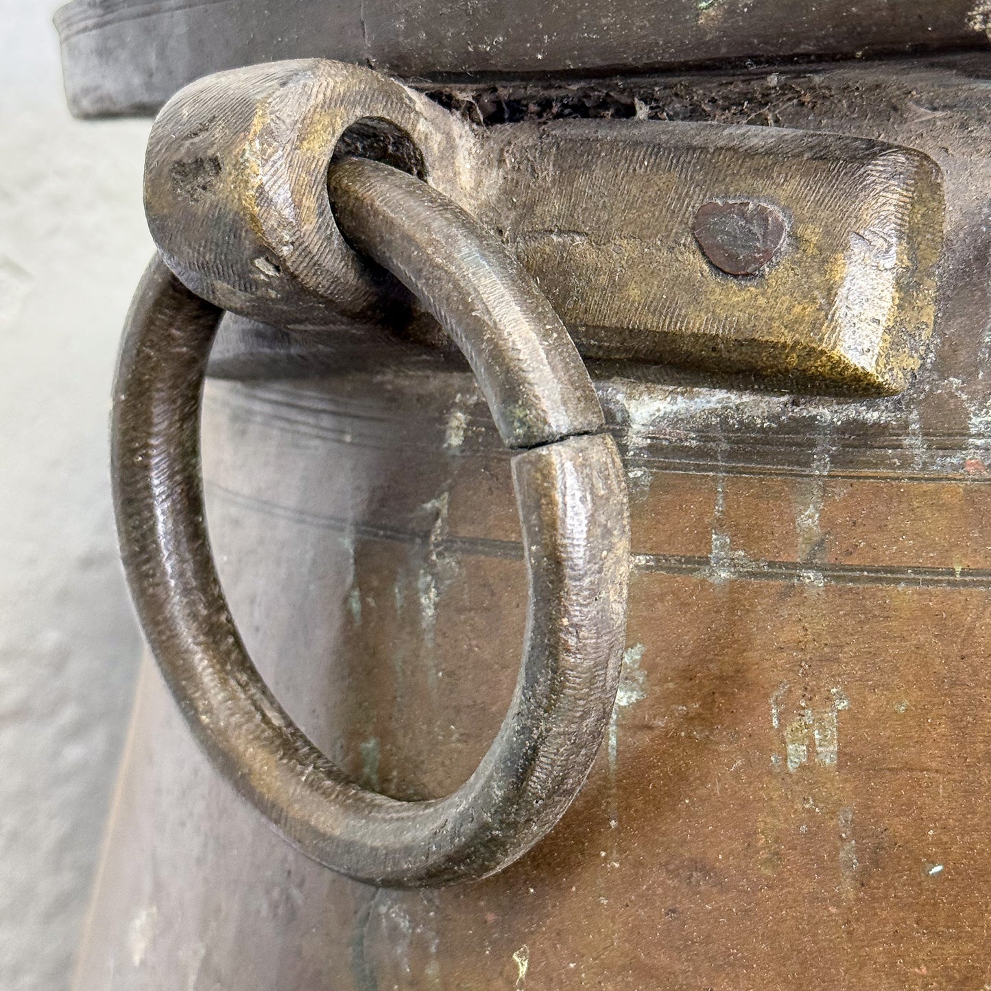 Close-up of a rusty metal handle on an old chest with a blurred background