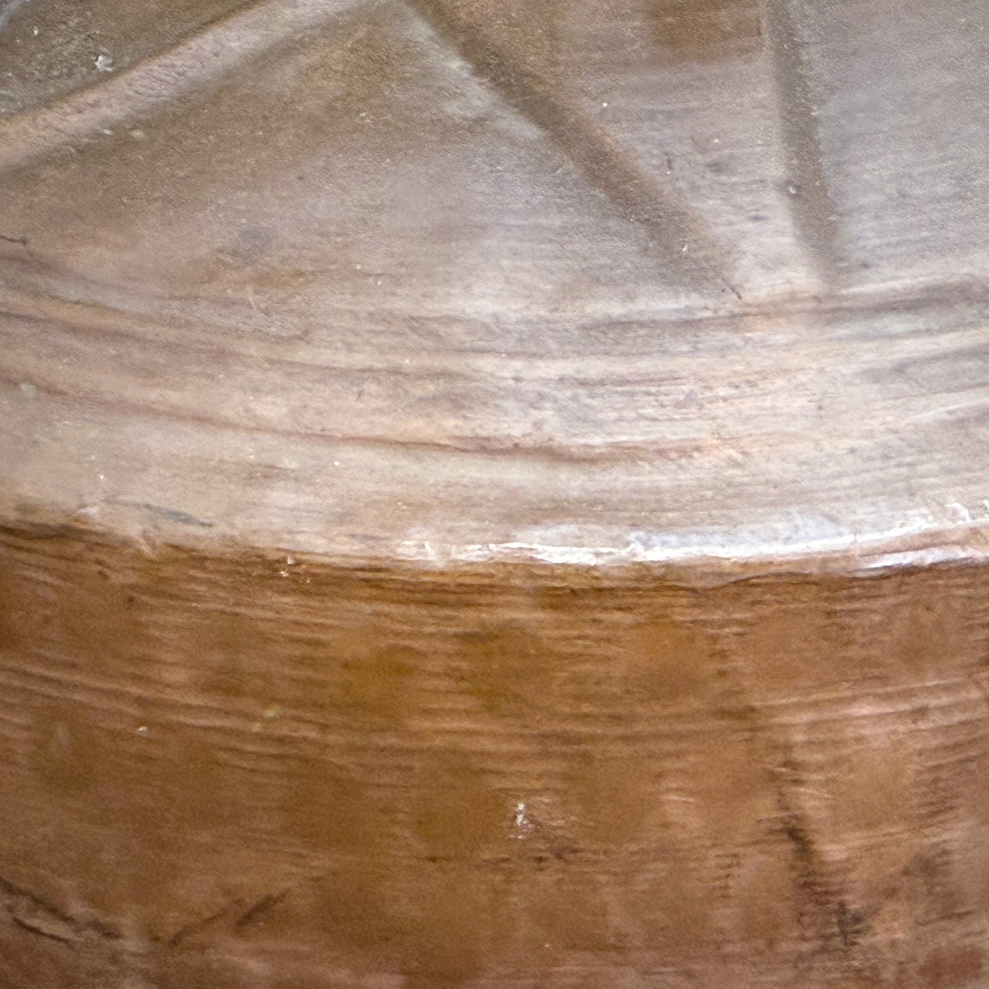 Close-up of a textured stone surface with brown and gray tones