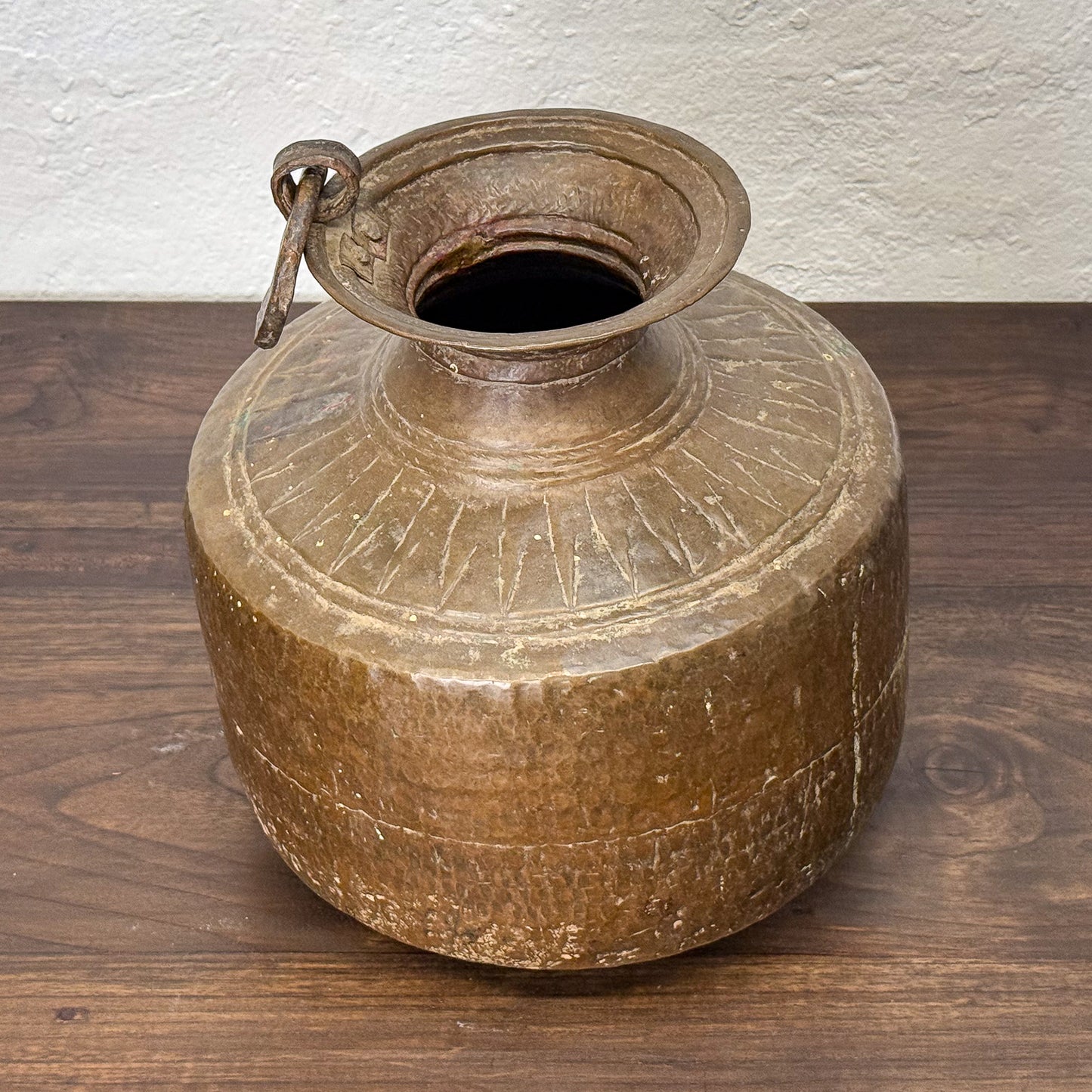 Vintage brown ceramic jar with lid on a wooden surface