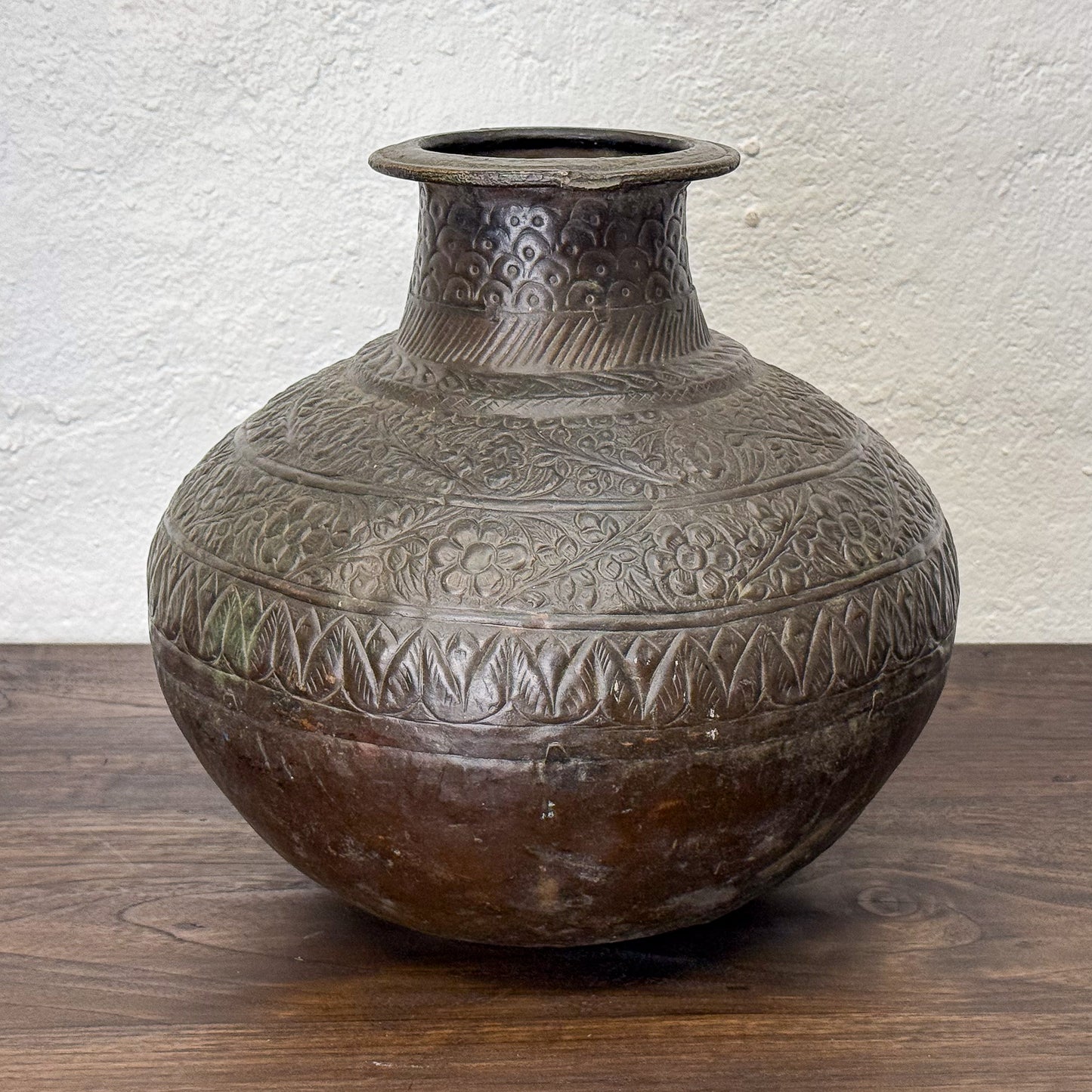 Decorative ceramic vase with intricate patterns on a wooden surface