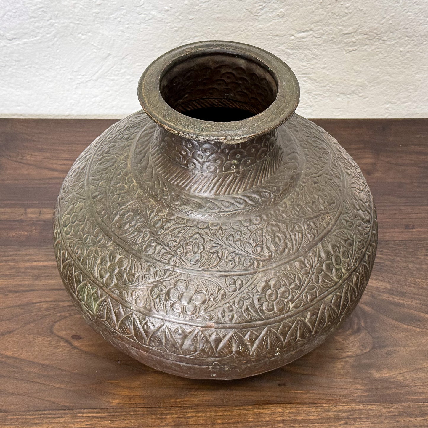 Decorative ceramic vase with intricate patterns on a wooden surface