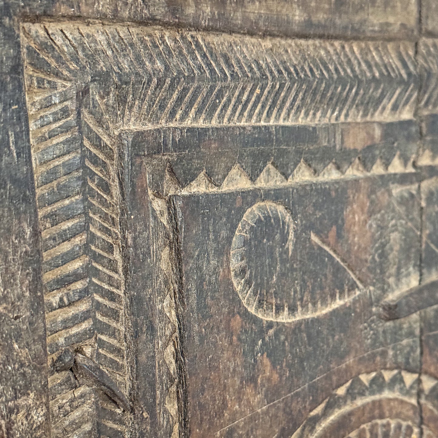 Close-up of a wooden panel with intricate carvings and patterns