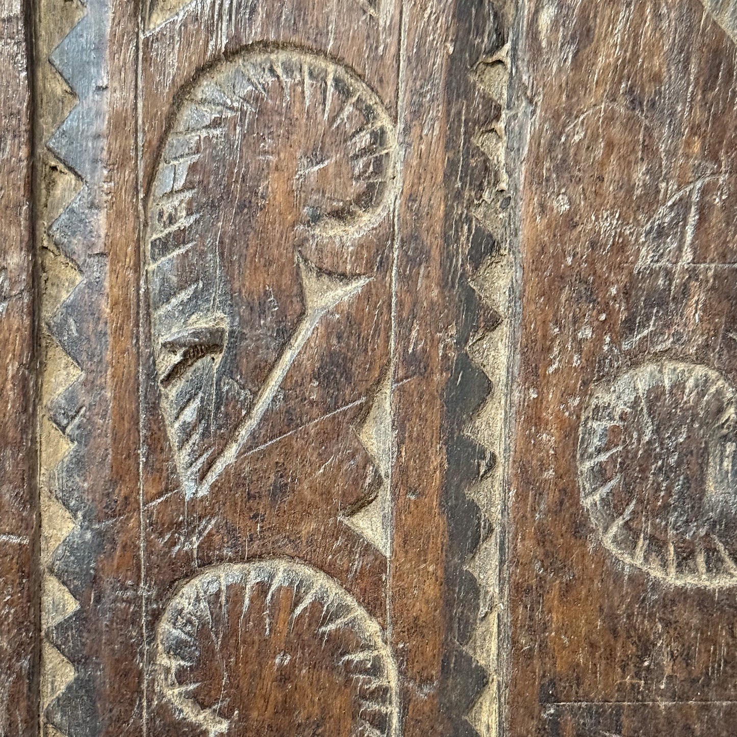 Close-up of a wooden panel with intricate carvings