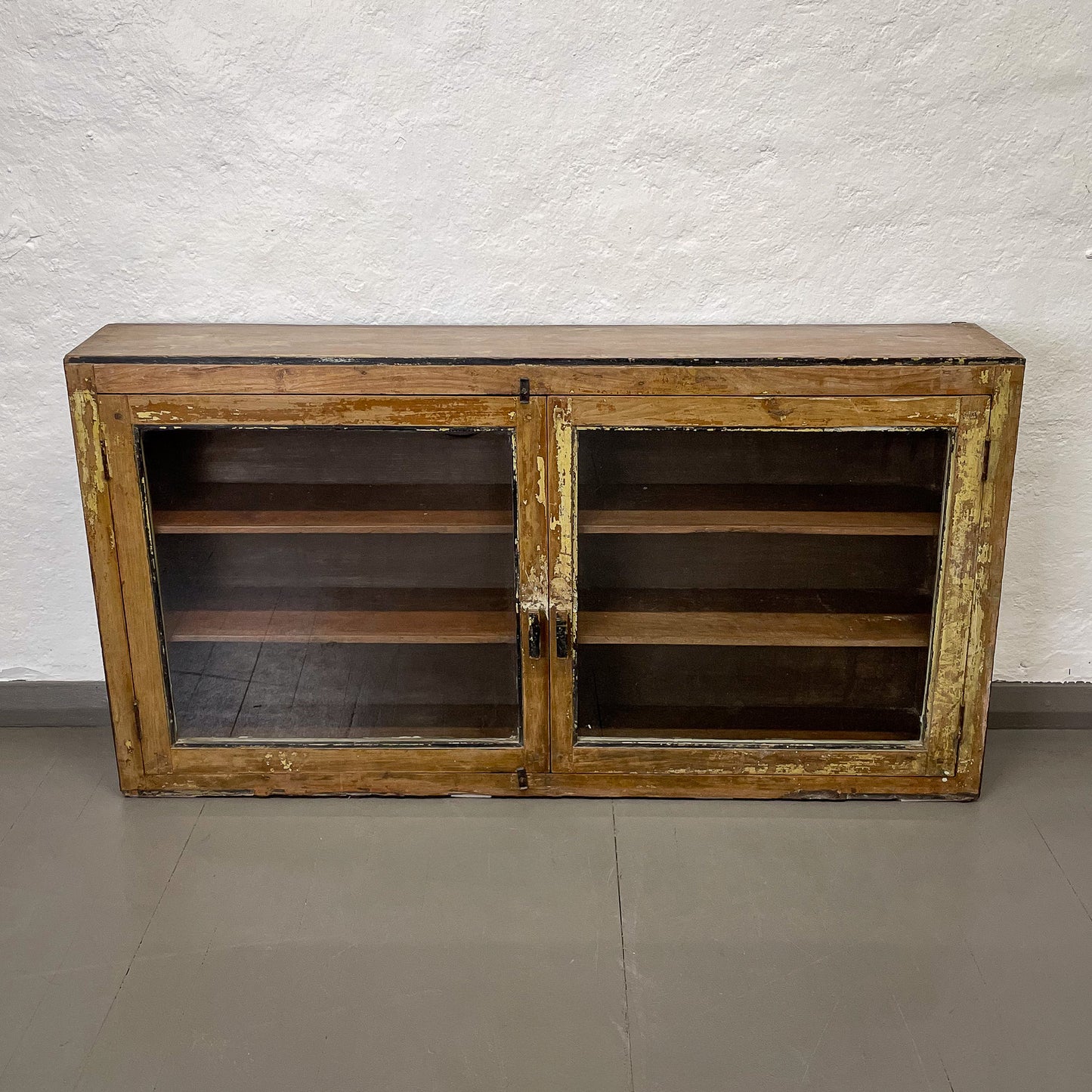 Wooden cabinet with glass doors on a plain background