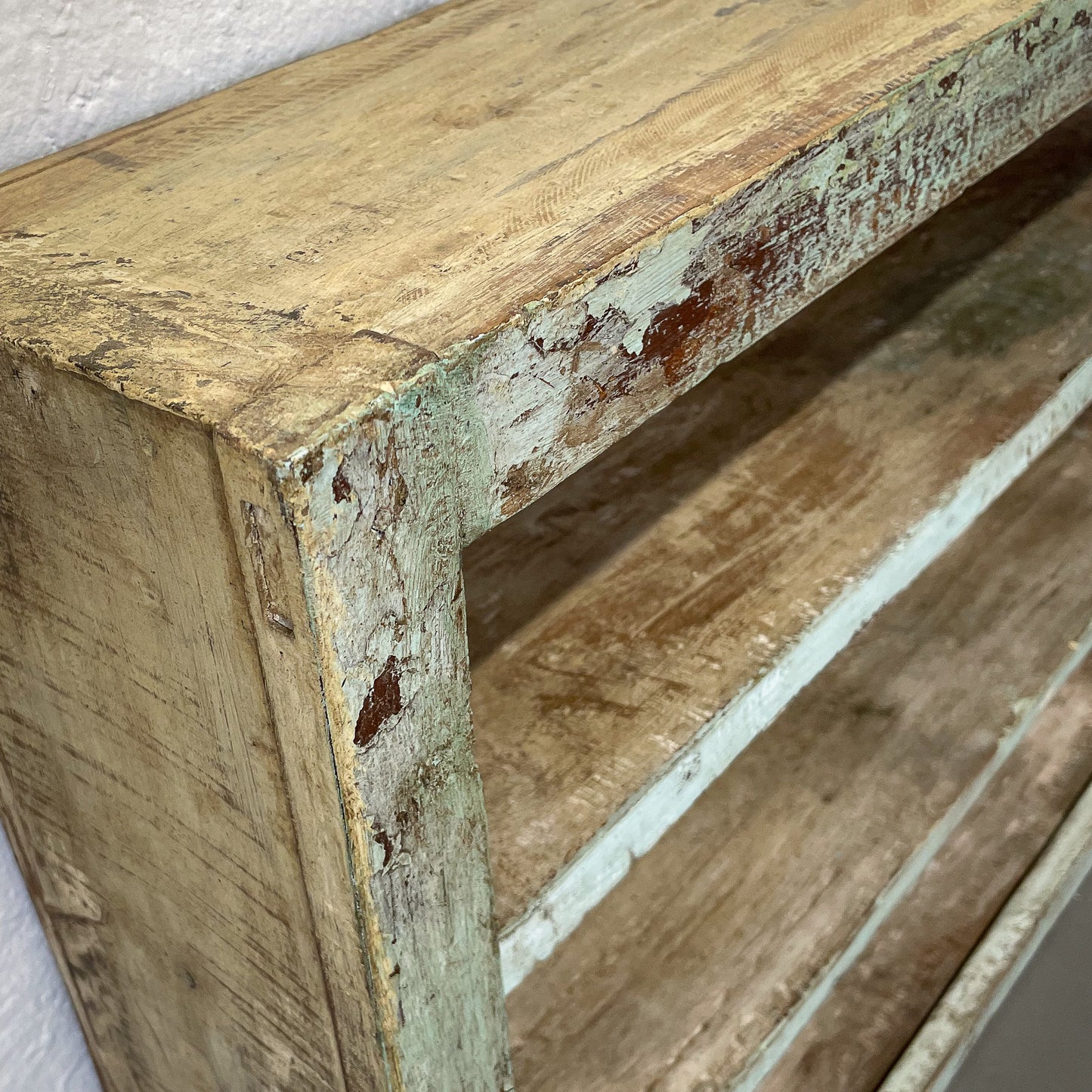 Close-up of a wooden shelf with weathered surface