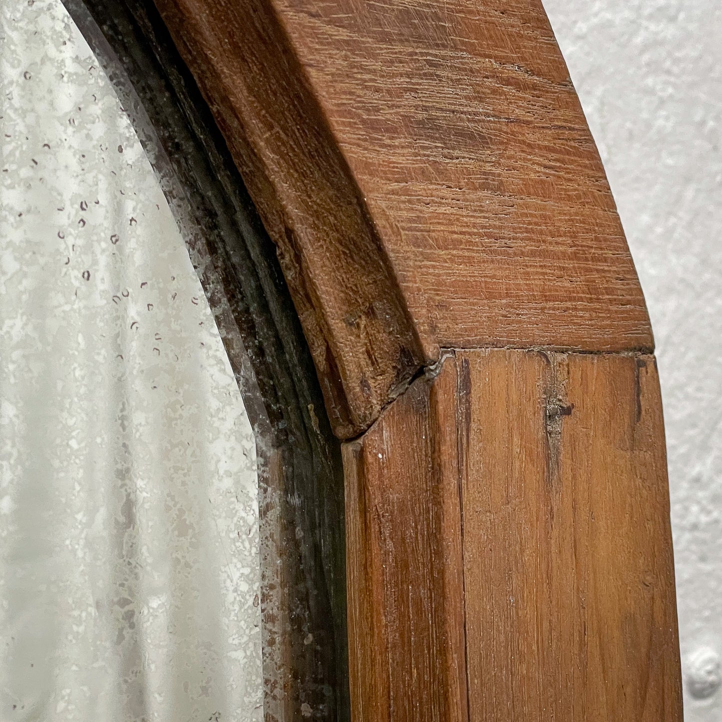 Close-up of wooden flooring with a white textured background
