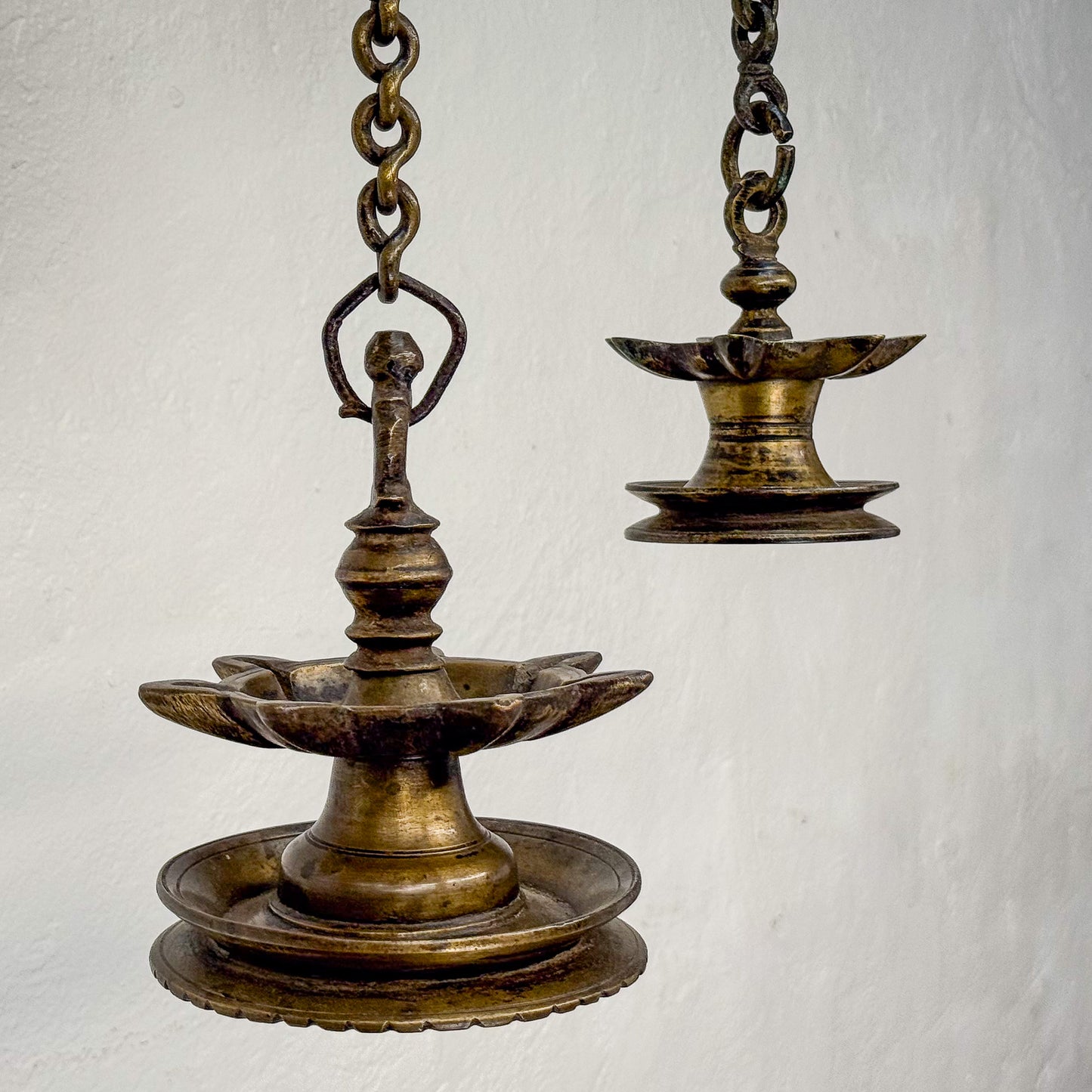 Bronze hanging oil lamp on a light gray background