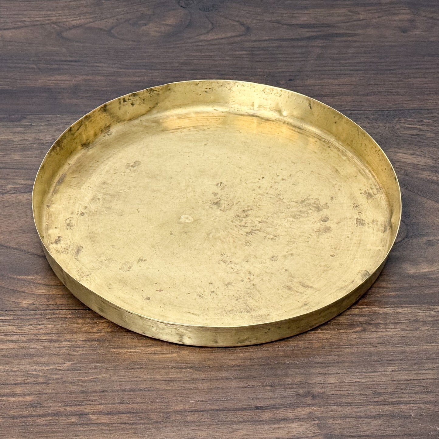 Gold tray on a wooden surface