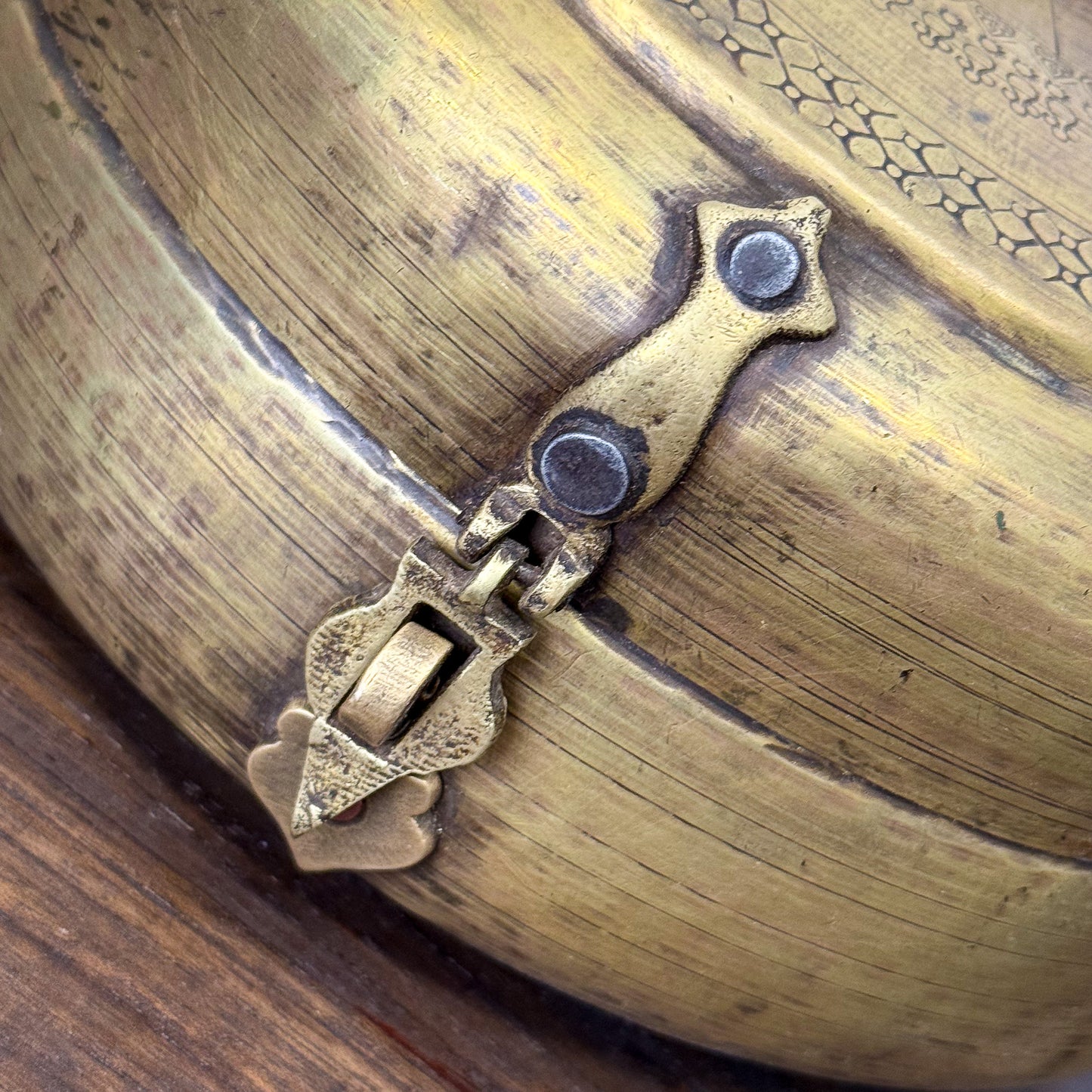 Close-up of a brass lock on a wooden box