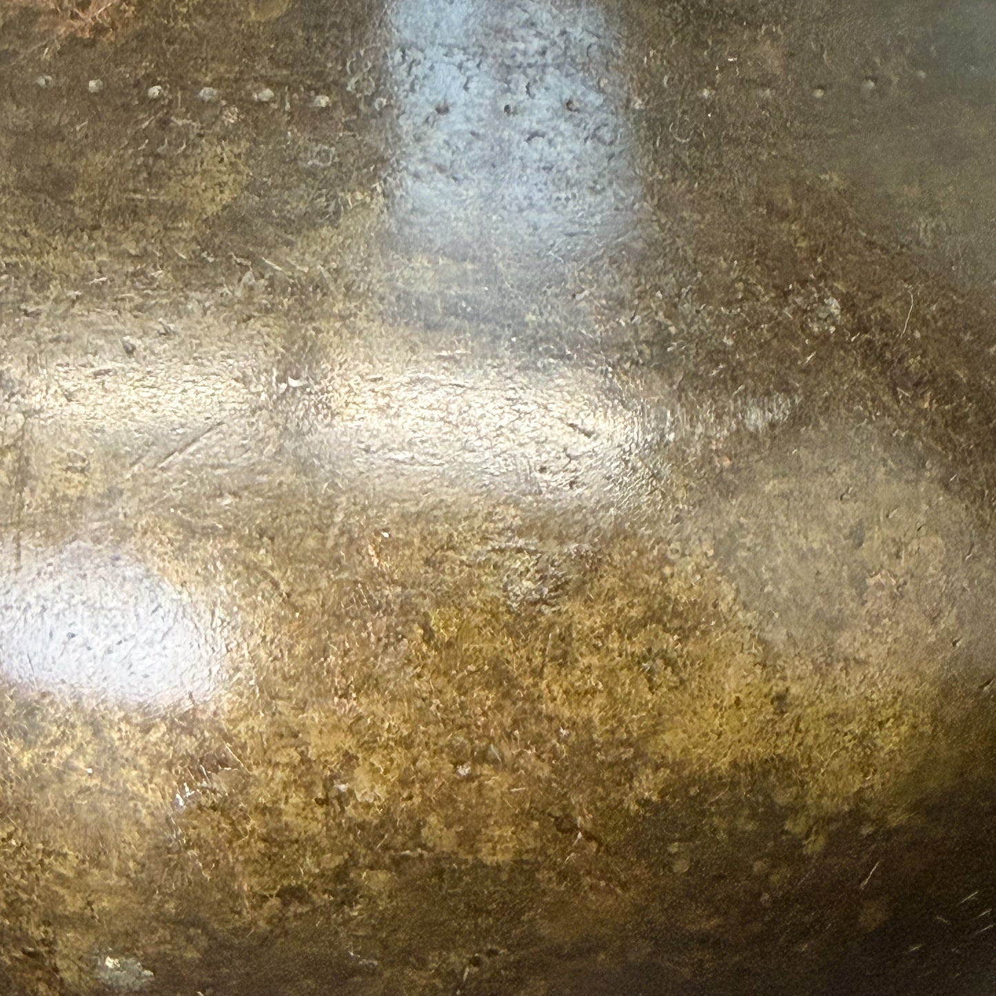 Close-up of a textured metallic surface with brown and gray tones