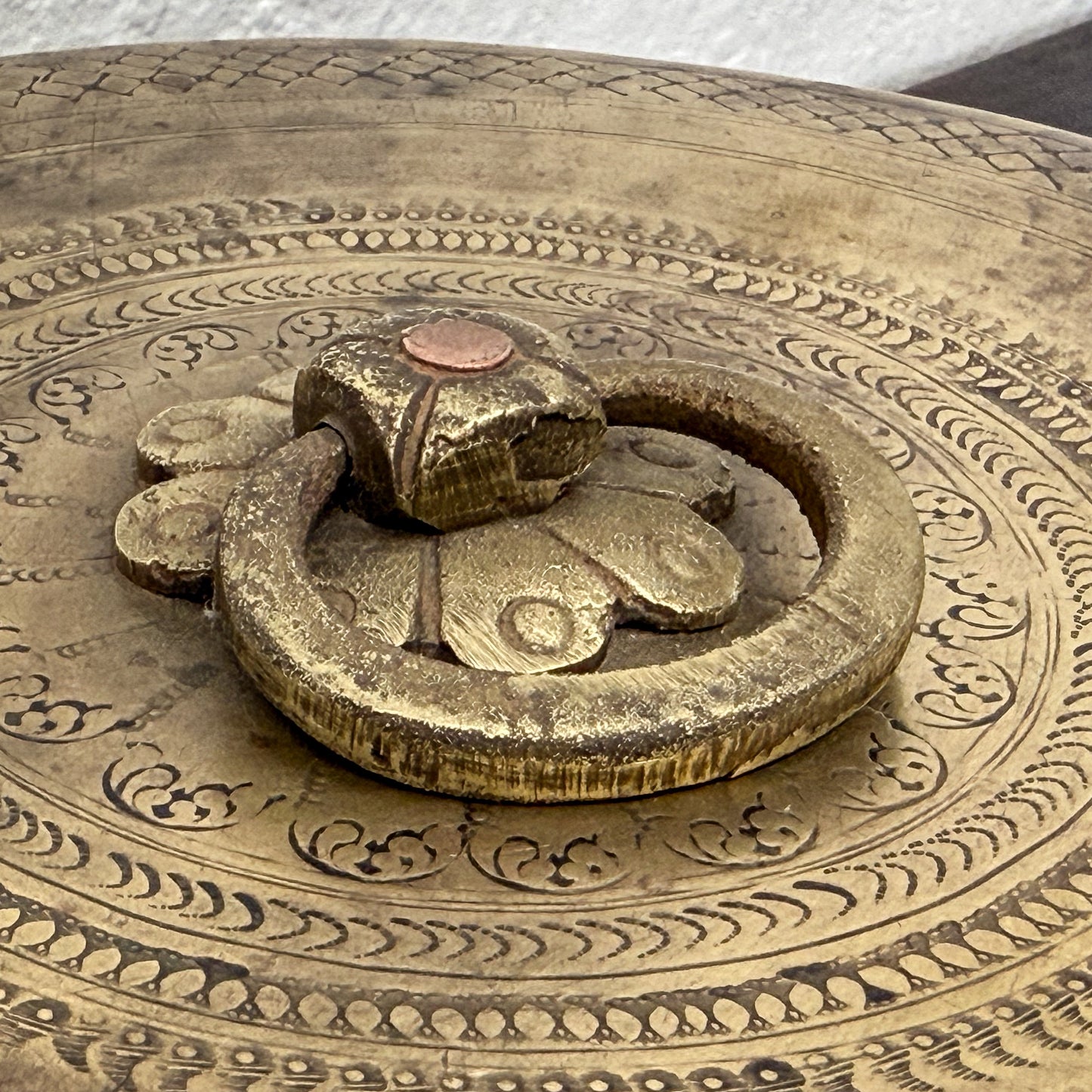 Decorative metal lock with intricate patterns on a circular object