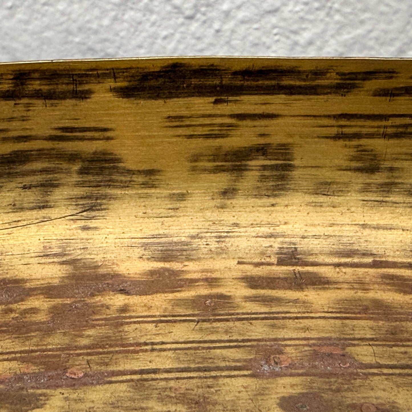 Close-up of a wooden surface with brown and black discoloration