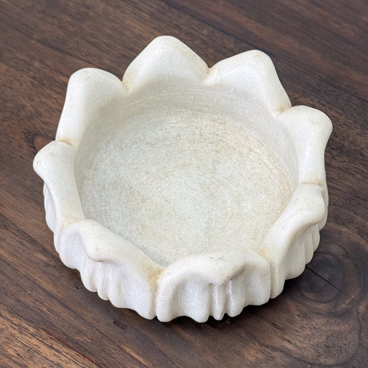White stone bowl on a wooden surface