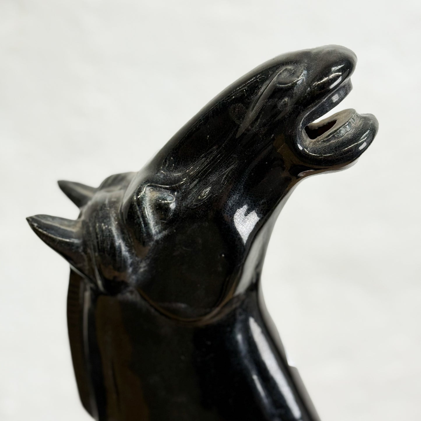 Black horse head car mascot on a white background