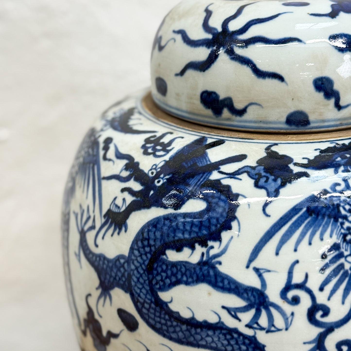 Ceramic jar with blue dragon design on a white background