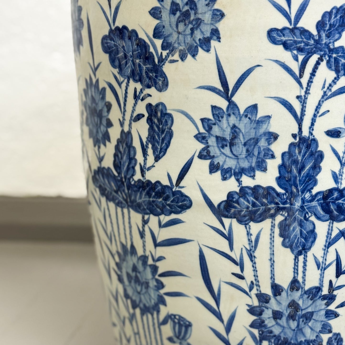 Close-up of a ceramic vase with blue floral pattern on a white background