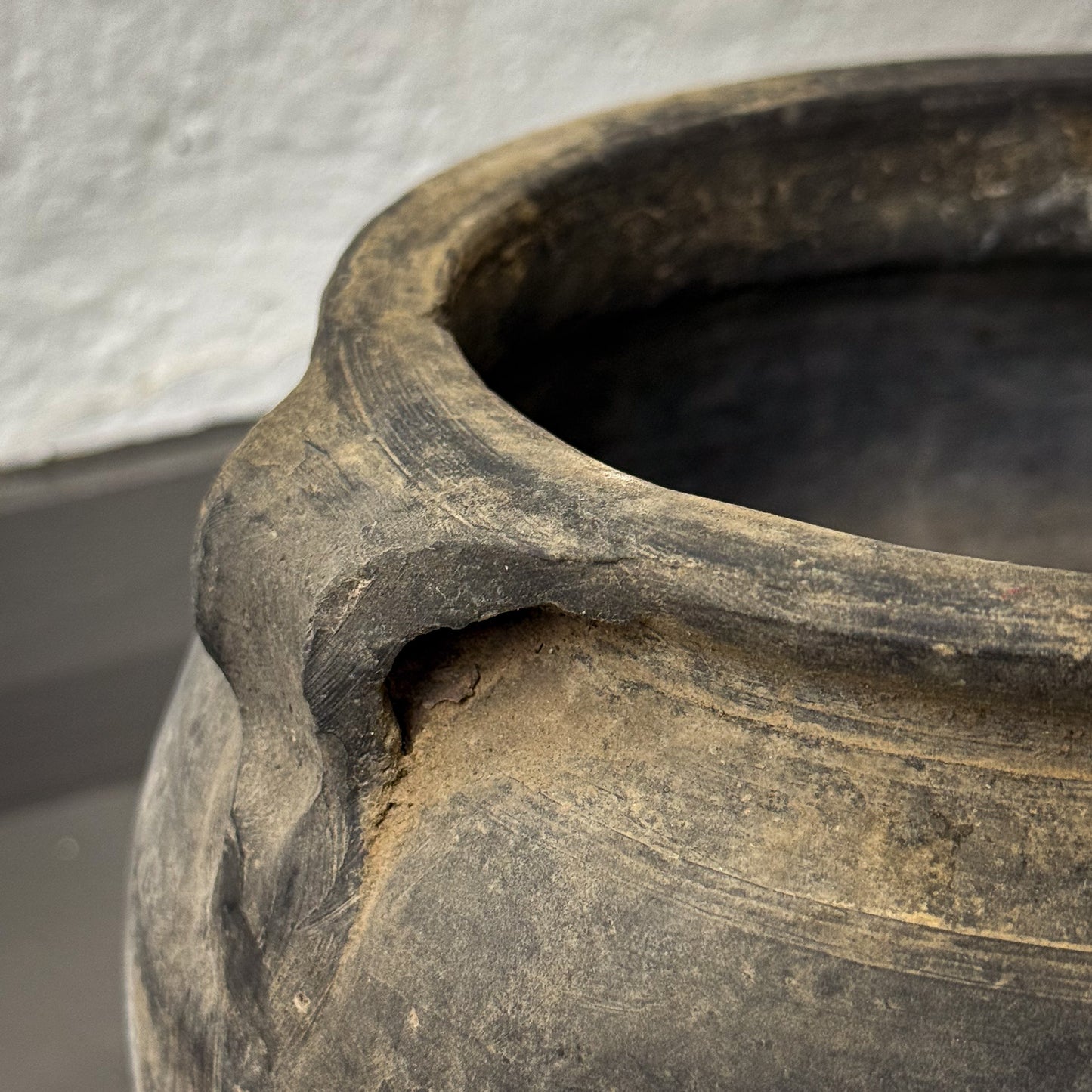 Close-up of an ancient pot with a textured surface
