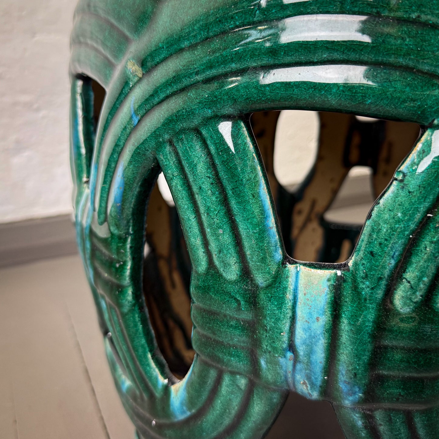 Close-up of a green ceramic vase with textured surface