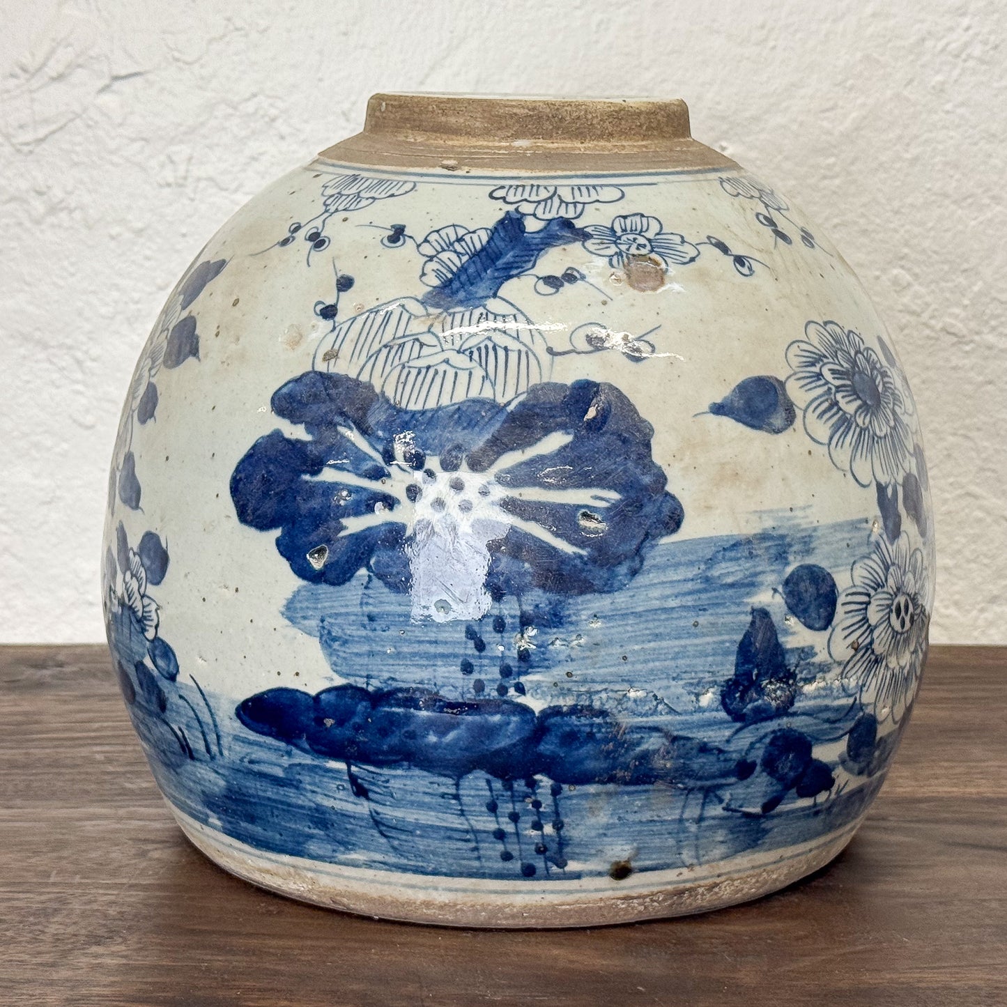 Ceramic jar with blue floral patterns on a wooden surface