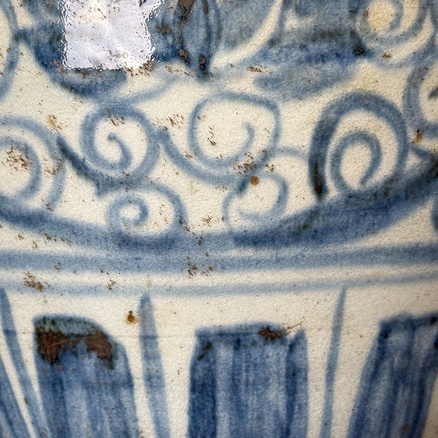 Close-up of blue and white ceramic tile with intricate patterns