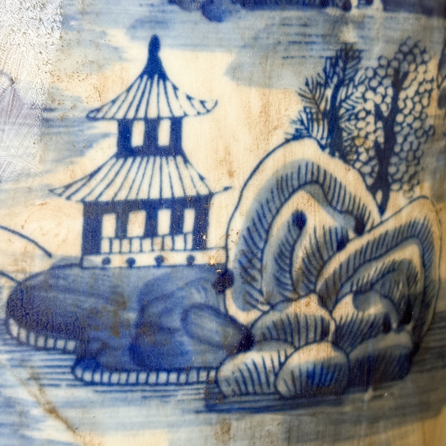 Blue and white ceramic tile with a pagoda and landscape design