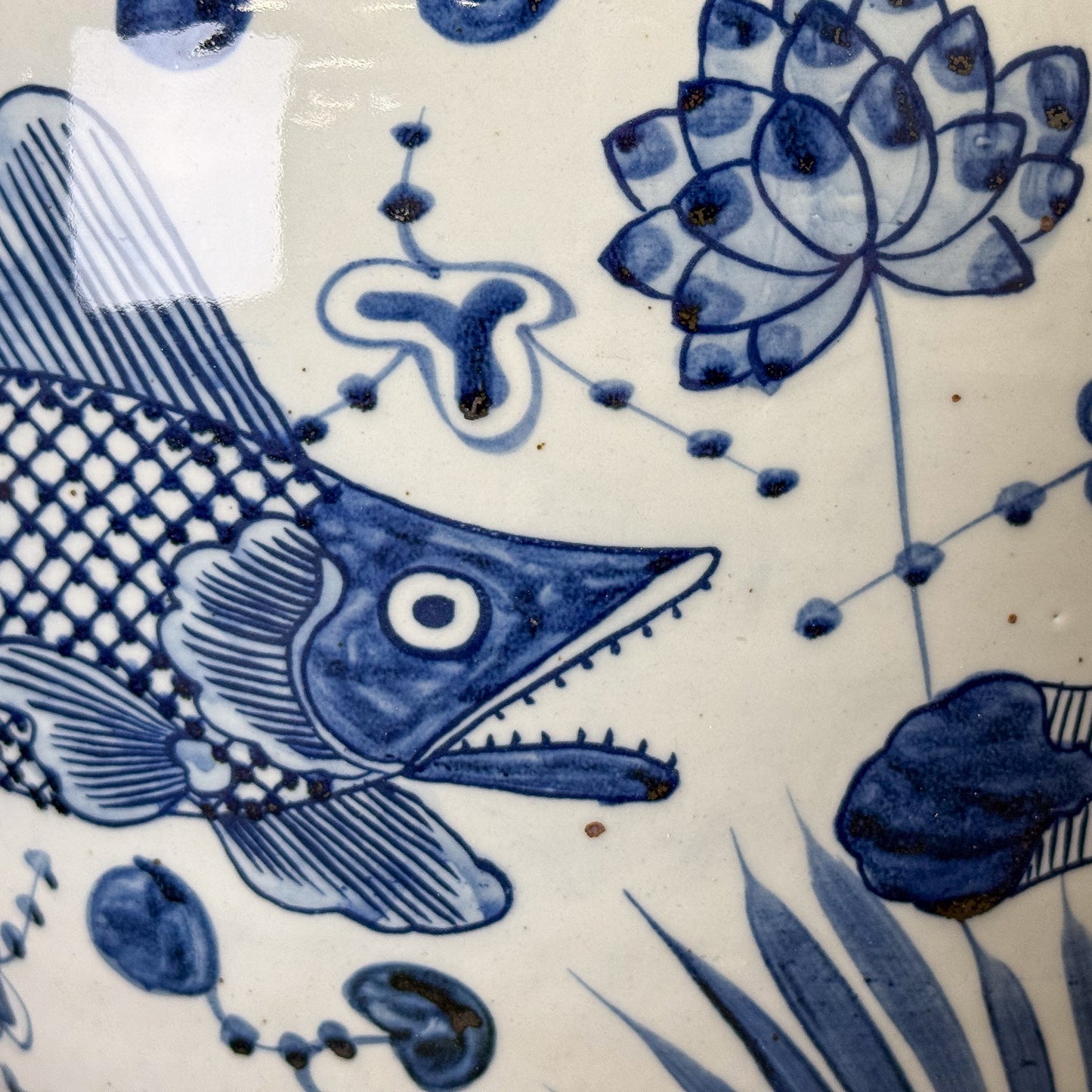 Close-up of blue floral and fish design on a white background