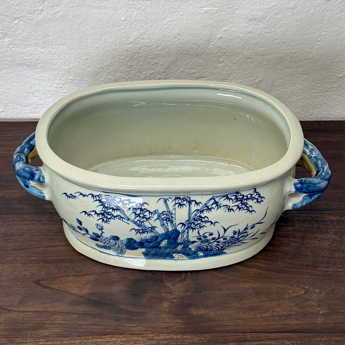 Ceramic dish with blue floral patterns on a wooden surface