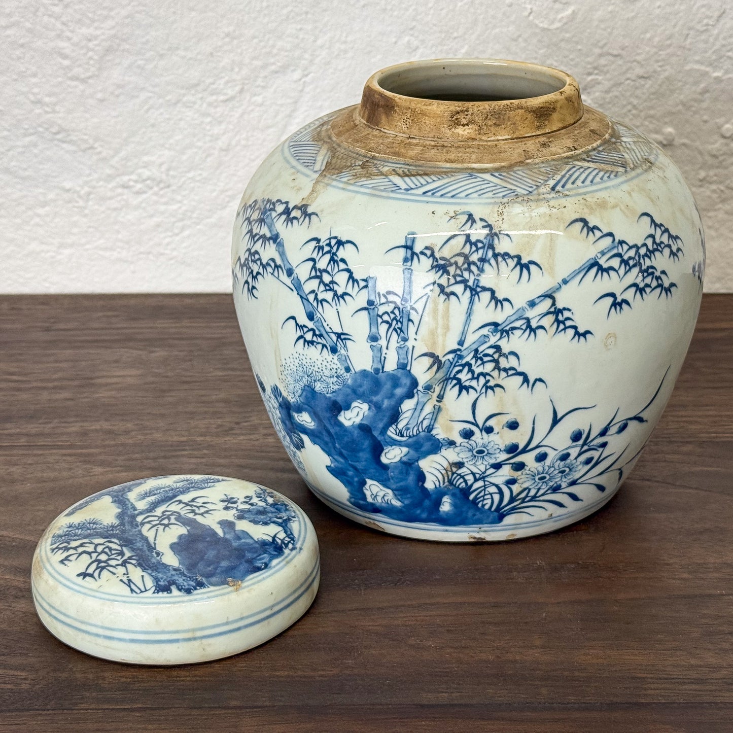 Blue and white ceramic jar with lid on a wooden surface