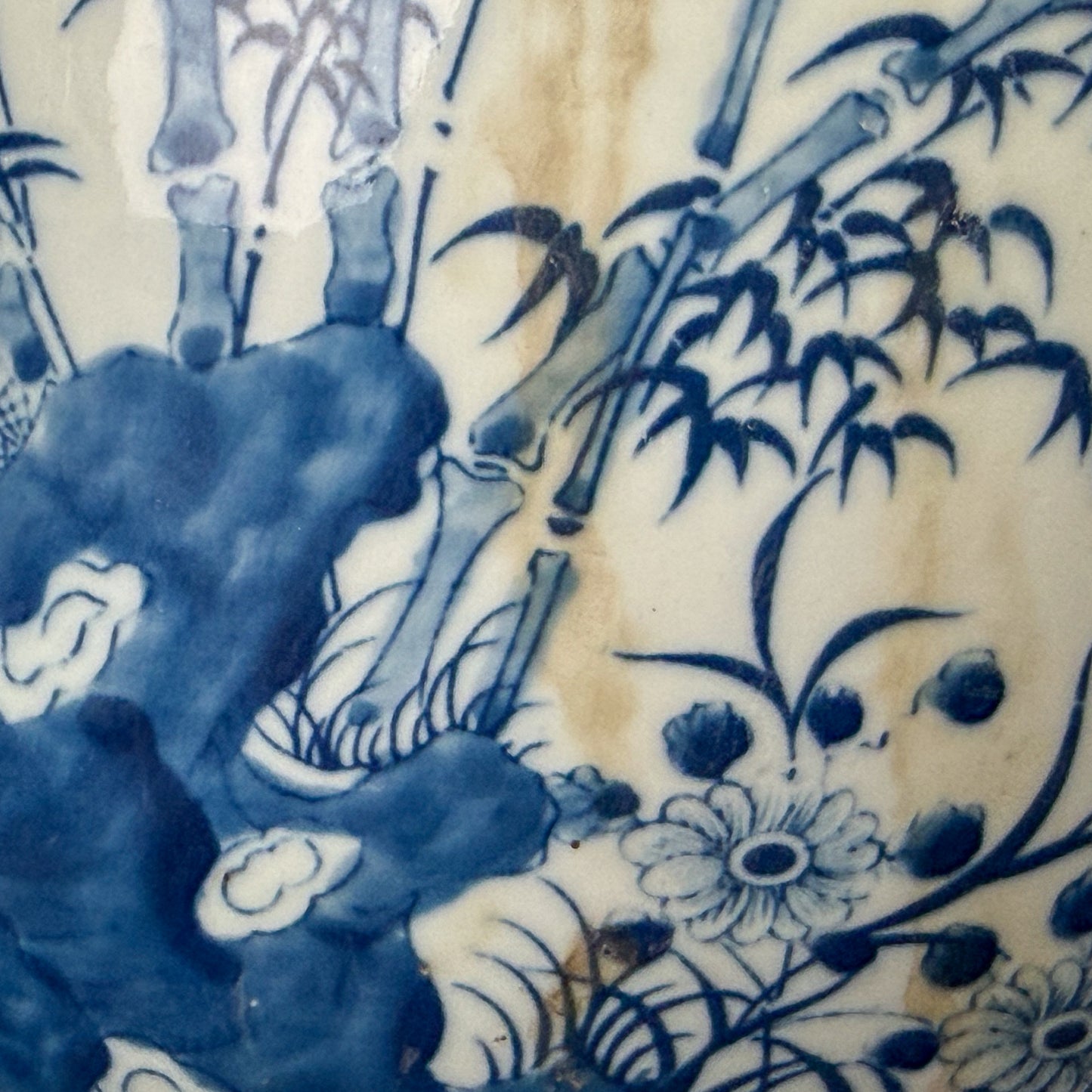 Close-up of blue and white floral and bamboo pattern on ceramic