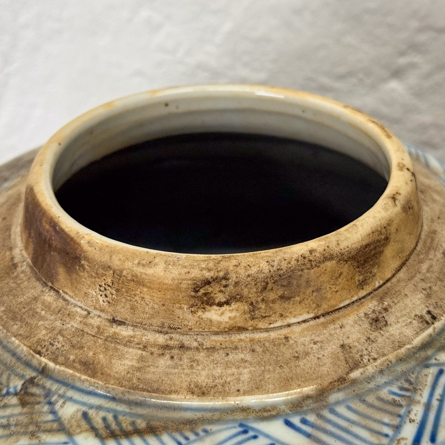 Close-up of a ceramic pot with a lid on a white background