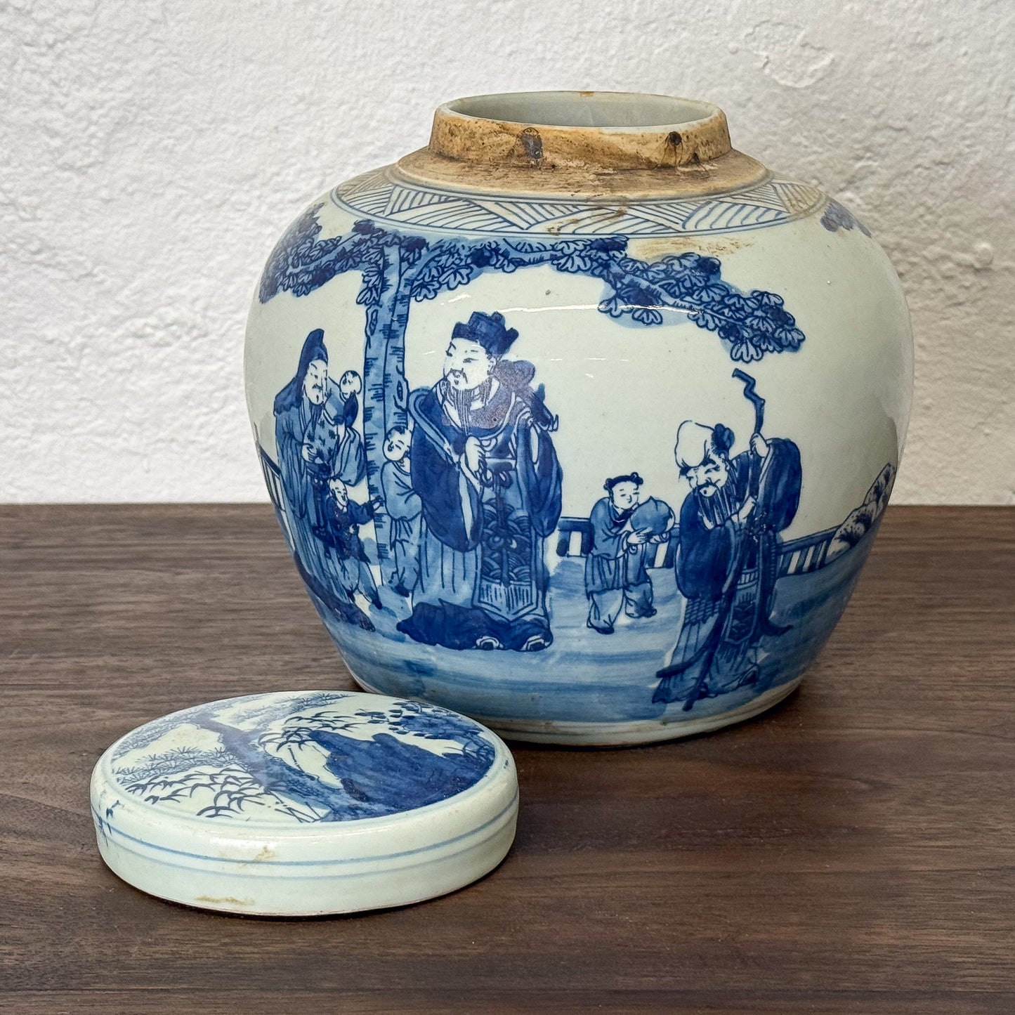 Blue and white ceramic jar with lid on a wooden surface
