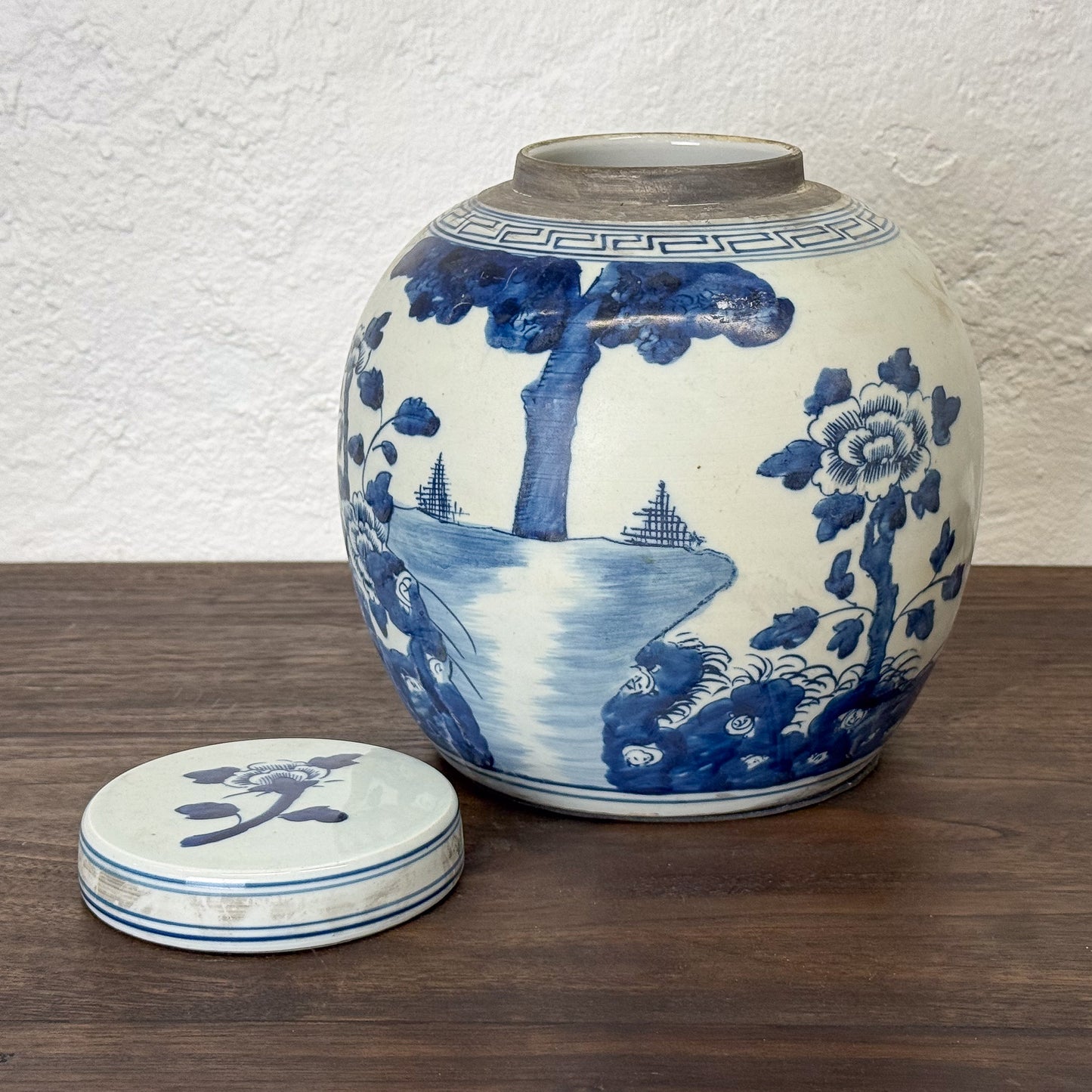 Blue and white ceramic jar with lid on a wooden surface