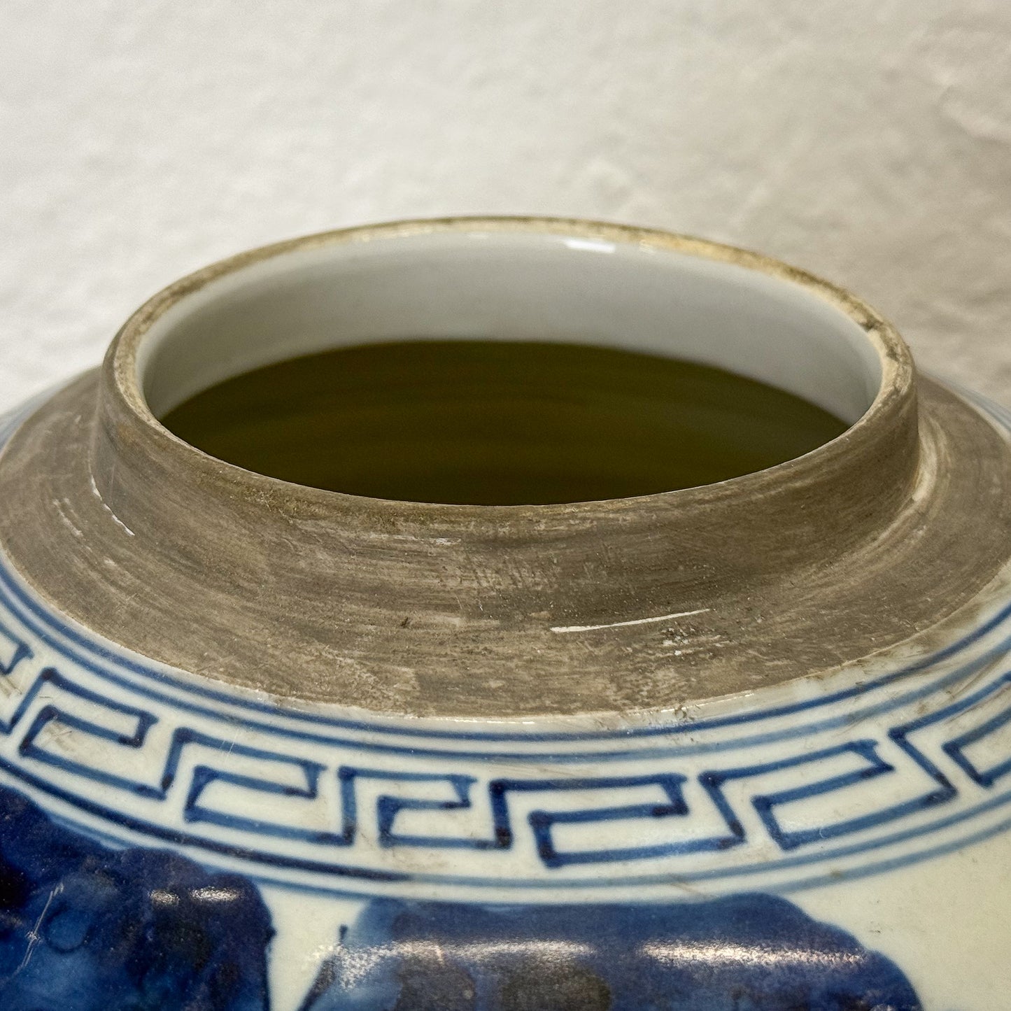 Close-up of a ceramic jar with blue and white decorative patterns on a white background.