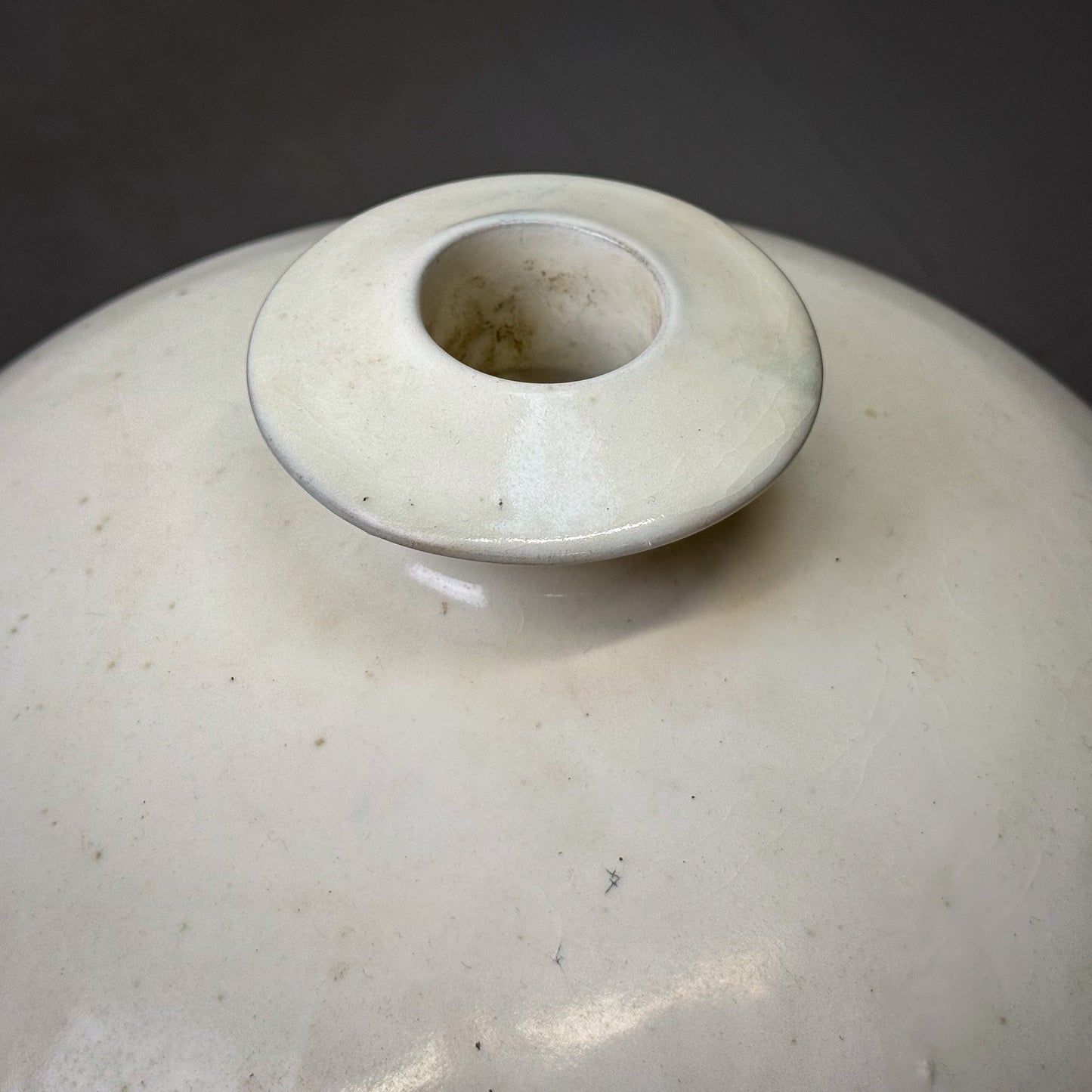 Close-up of a ceramic vase with a dark background