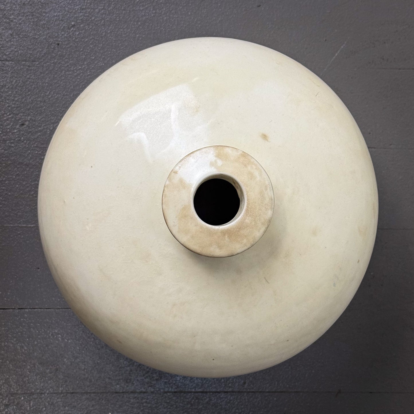 White ceramic vase on a dark gray background