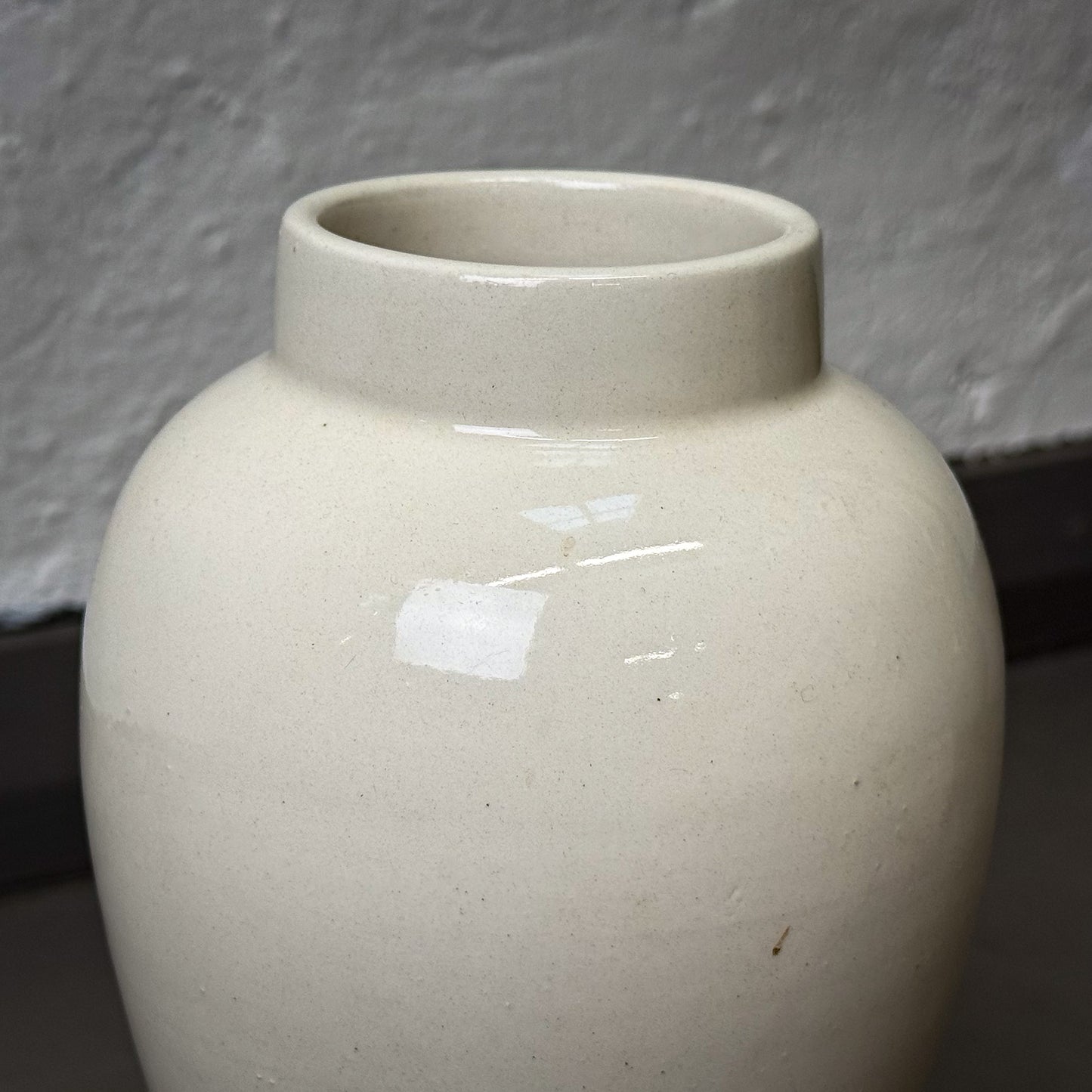 White ceramic vase on a gray background