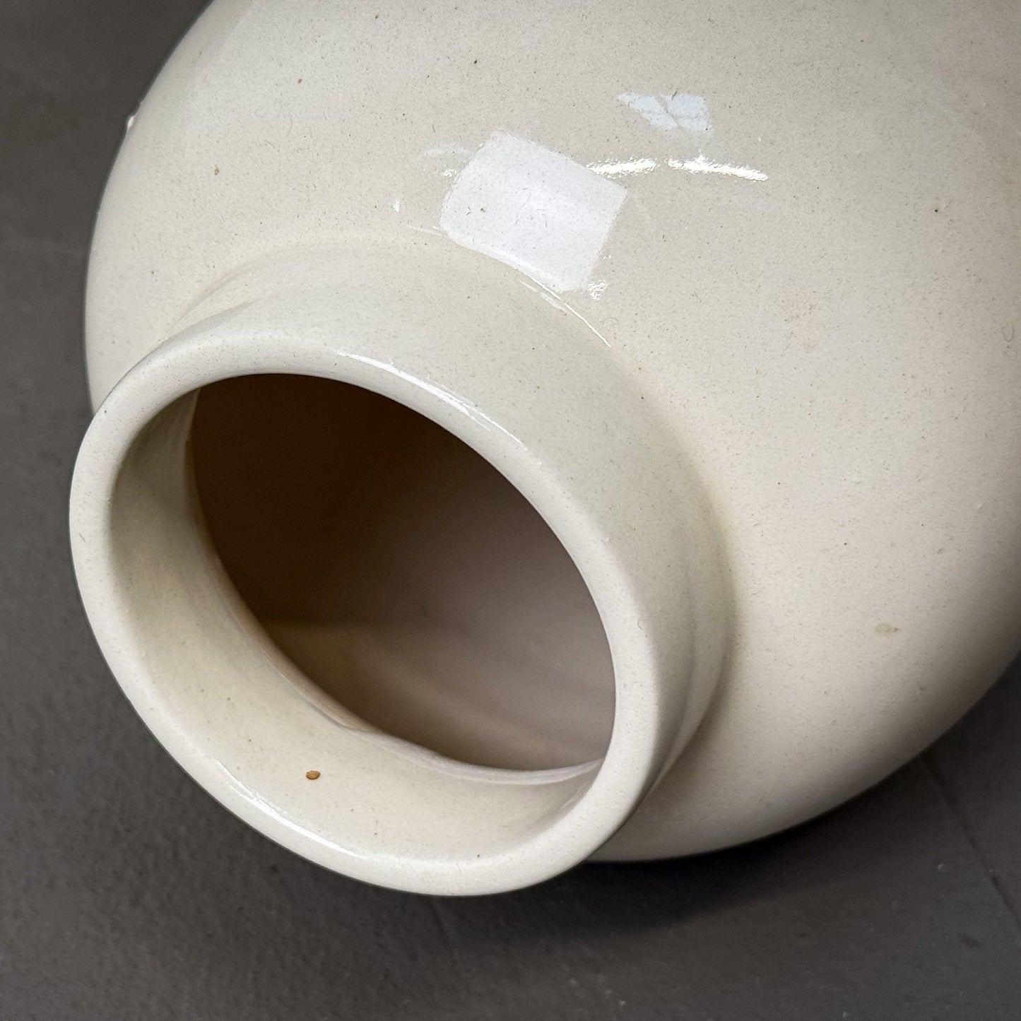 Close-up of a white ceramic vase on a gray background