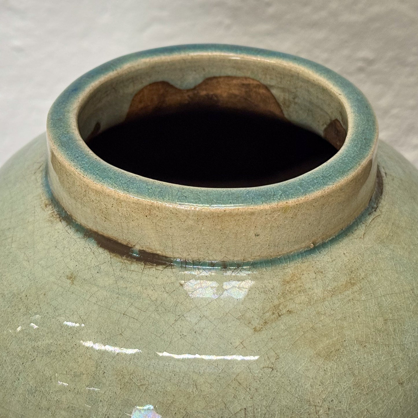 Close-up of a ceramic jar with a textured surface and visible glaze.