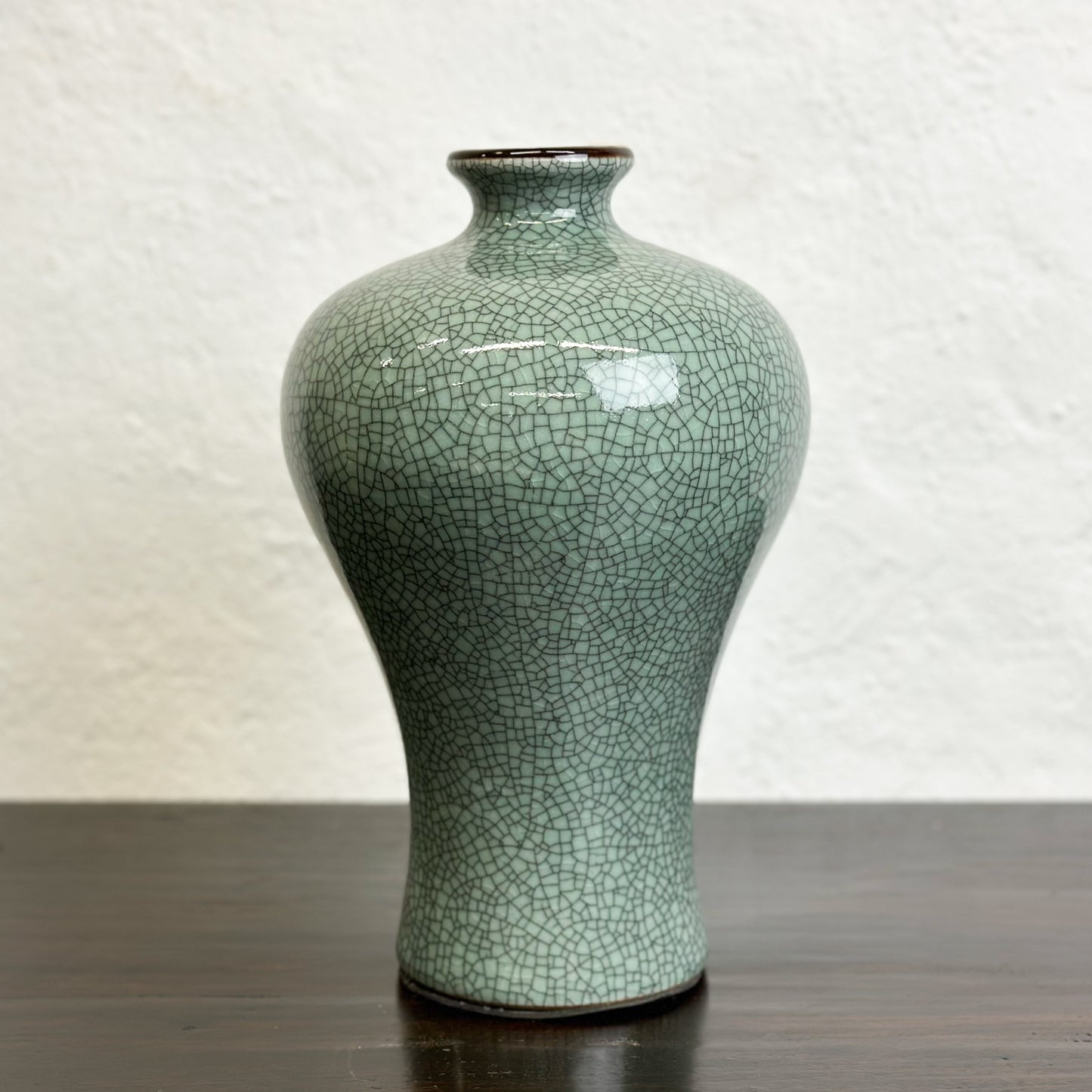 A Crackled Celadon Meiping Vase with a greenish color and a craquelure effect, displayed against a neutral background.