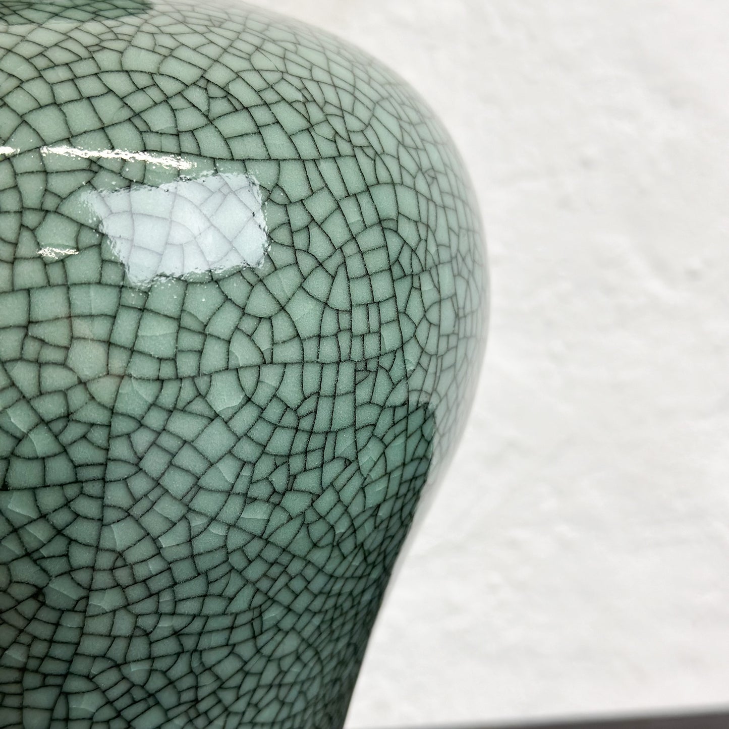 A Crackled Celadon Meiping Vase with a greenish color and a craquelure effect, displayed against a neutral background.