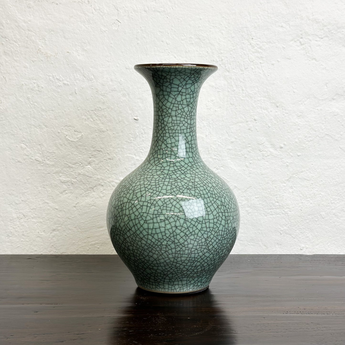 A crackled celadon globular vase with flared lip, displayed against a neutral background.