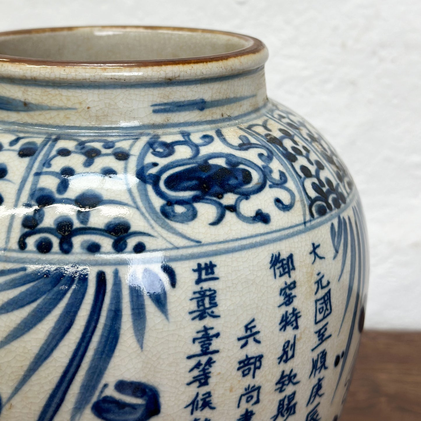 A blue and white porcelain vase with fish patterns, displayed against a neutral background.