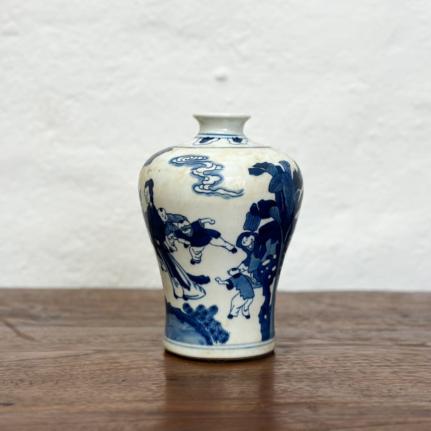 A blue and white porcelain meiping vase with floral patterns, displayed against a neutral background.