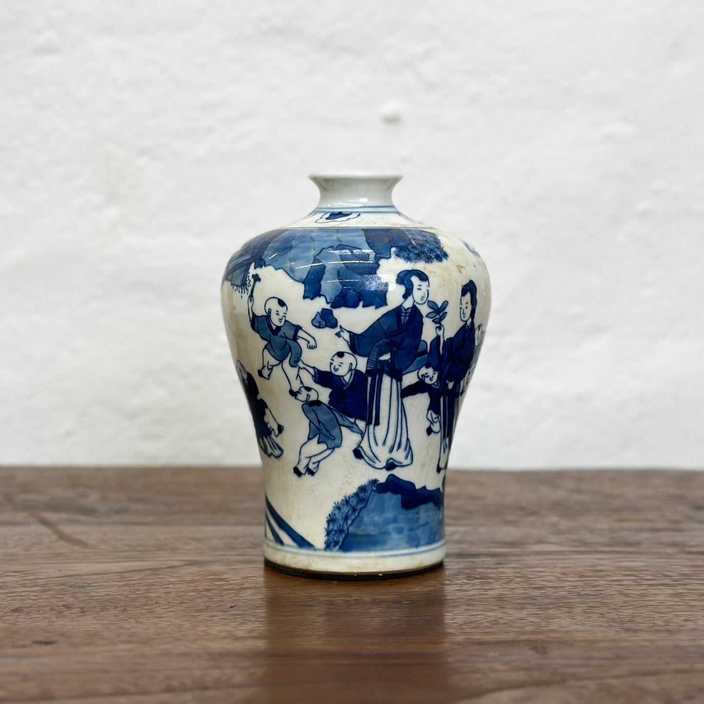 A blue and white porcelain meiping vase with floral patterns, displayed against a neutral background.