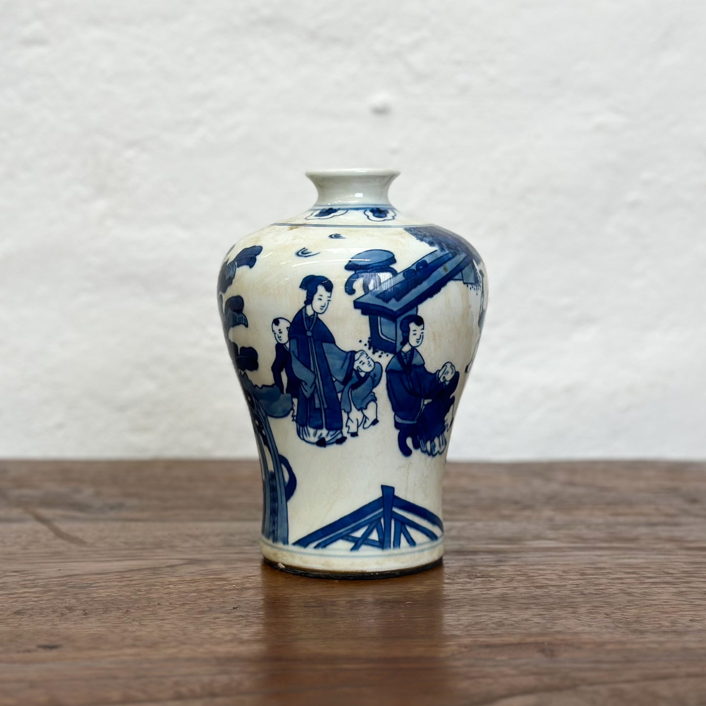 A blue and white porcelain meiping vase with floral patterns, displayed against a neutral background.