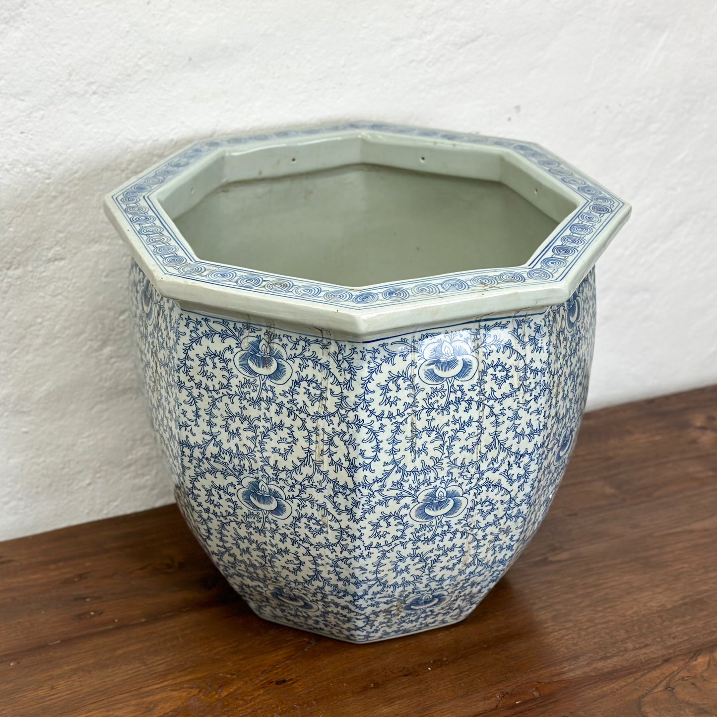 A blue and white porcelain planter with a floral pattern, displayed against a neutral background.