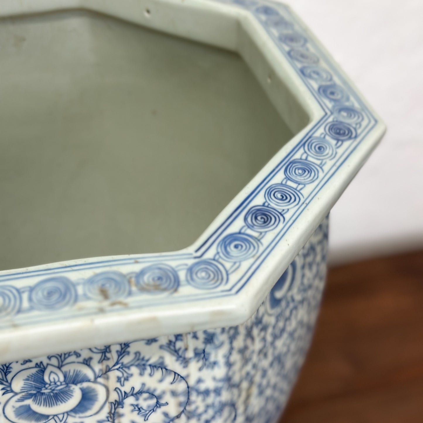 A blue and white porcelain planter with a floral pattern, displayed against a neutral background.