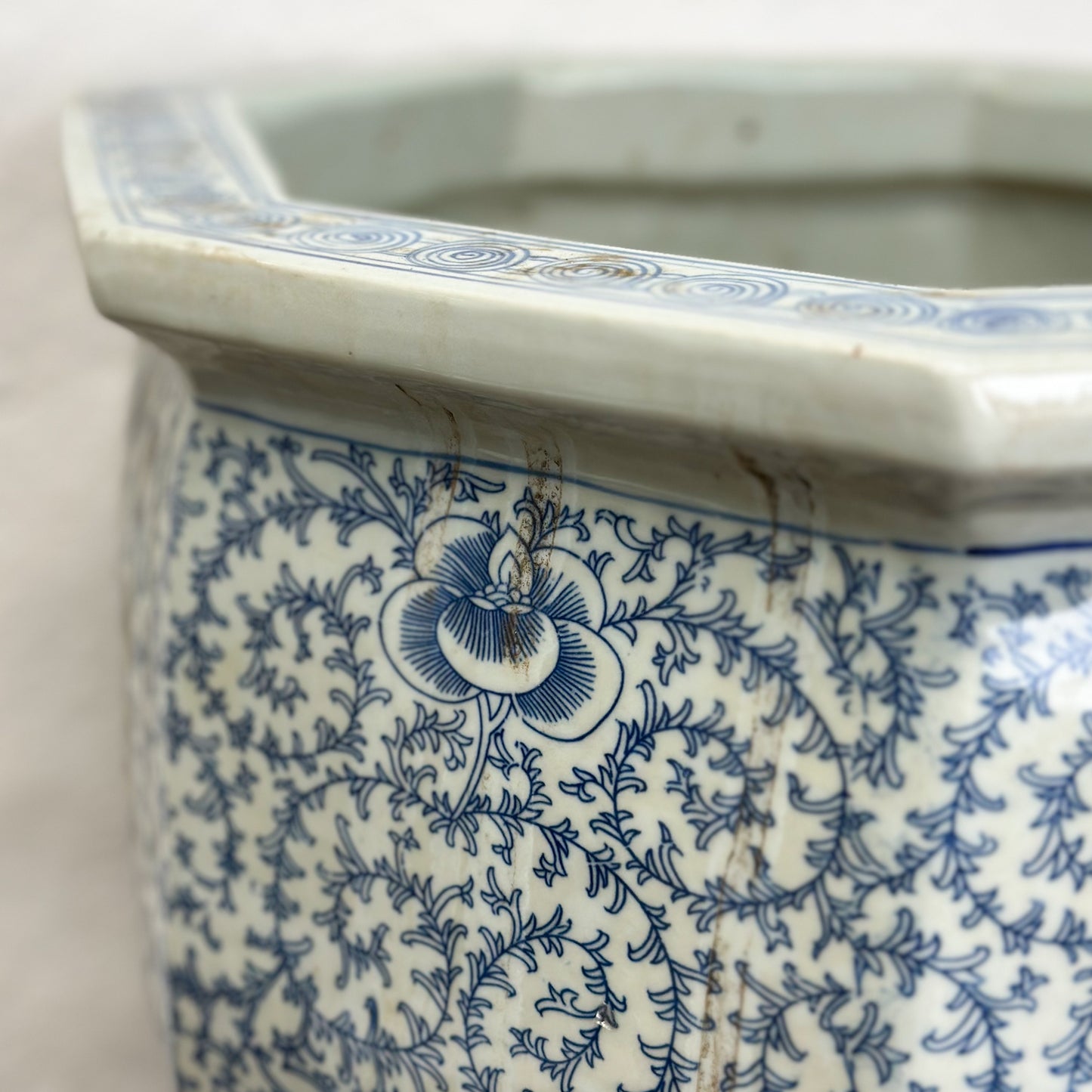 A blue and white porcelain planter with a floral pattern, displayed against a neutral background.
