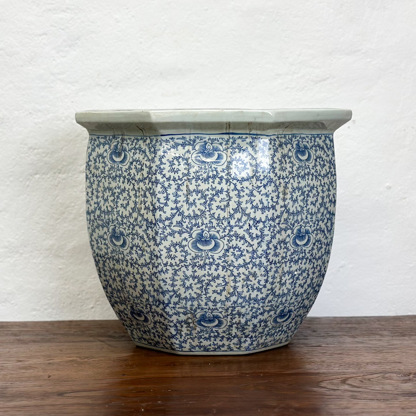 A blue and white porcelain planter with a floral pattern, displayed against a neutral background.